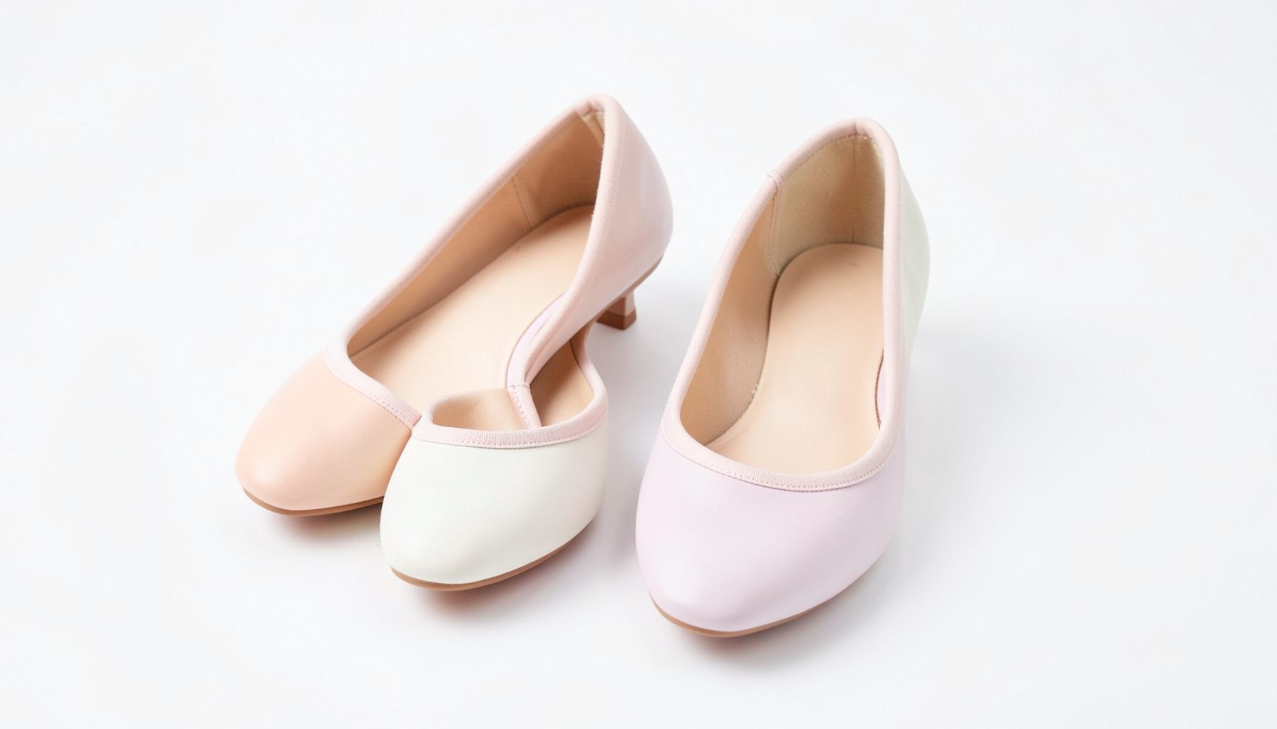 Sleek ballet pumps in soft pastel shades, neatly paired on a clean white background